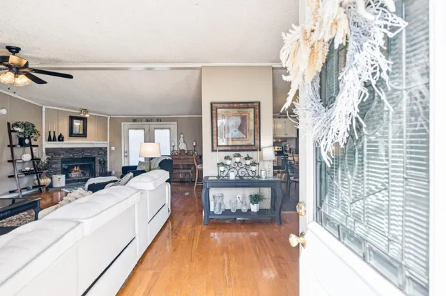 a living room with furniture a fireplace and a large window
