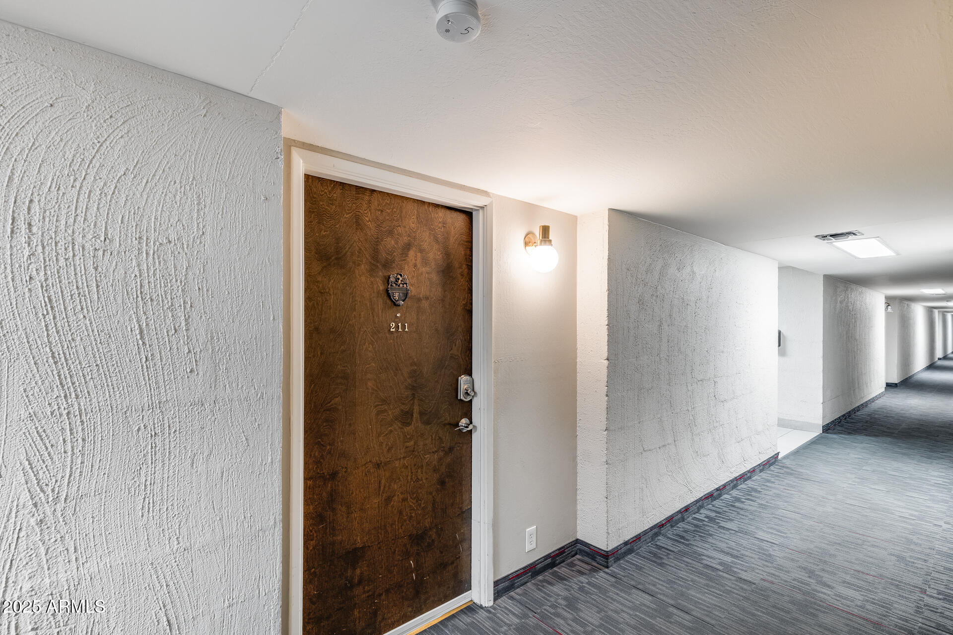 7820 East Camelback Road, Unit 211 Scottsdale, AZ 85251 - Photo 18 of 52 a view of a hallway with wooden floor
