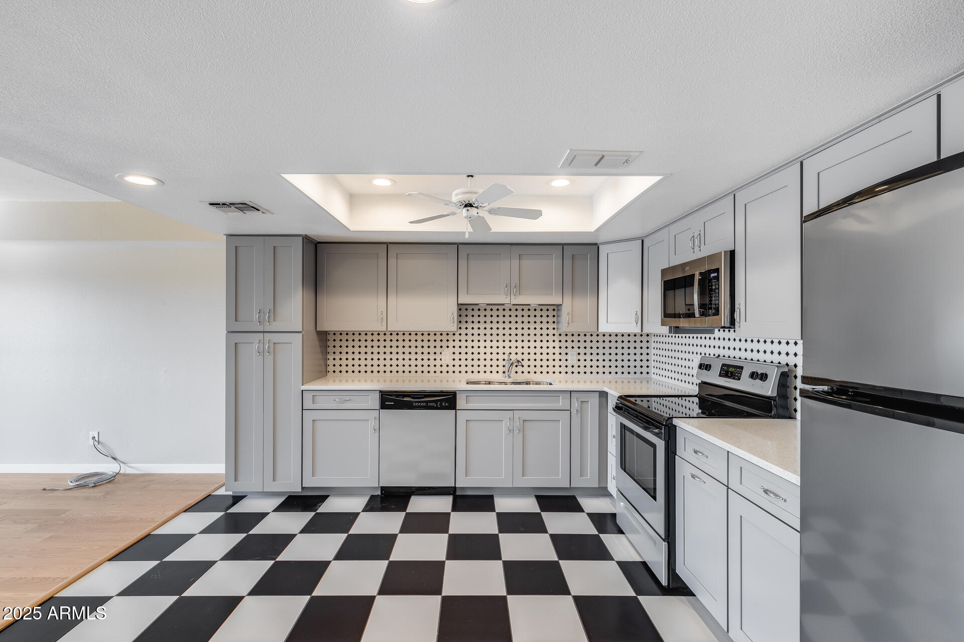 7820 East Camelback Road, Unit 211 Scottsdale, AZ 85251 - Photo 20 of 52 a kitchen with stainless steel appliances a sink a stove a refrigerator and cabinets