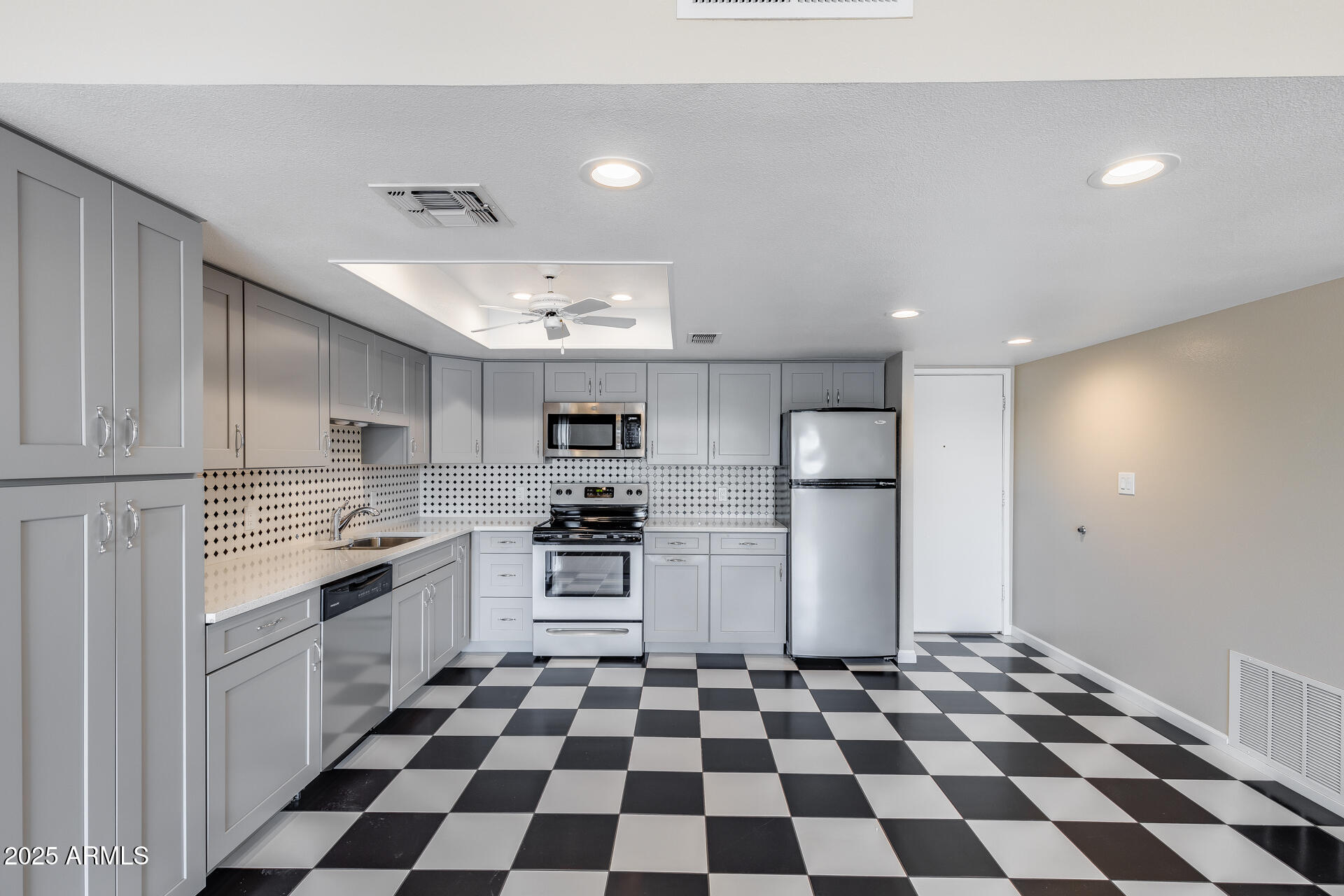 7820 East Camelback Road, Unit 211 Scottsdale, AZ 85251 - Photo 21 of 52 a kitchen with stainless steel appliances granite countertop a refrigerator and a stove top oven