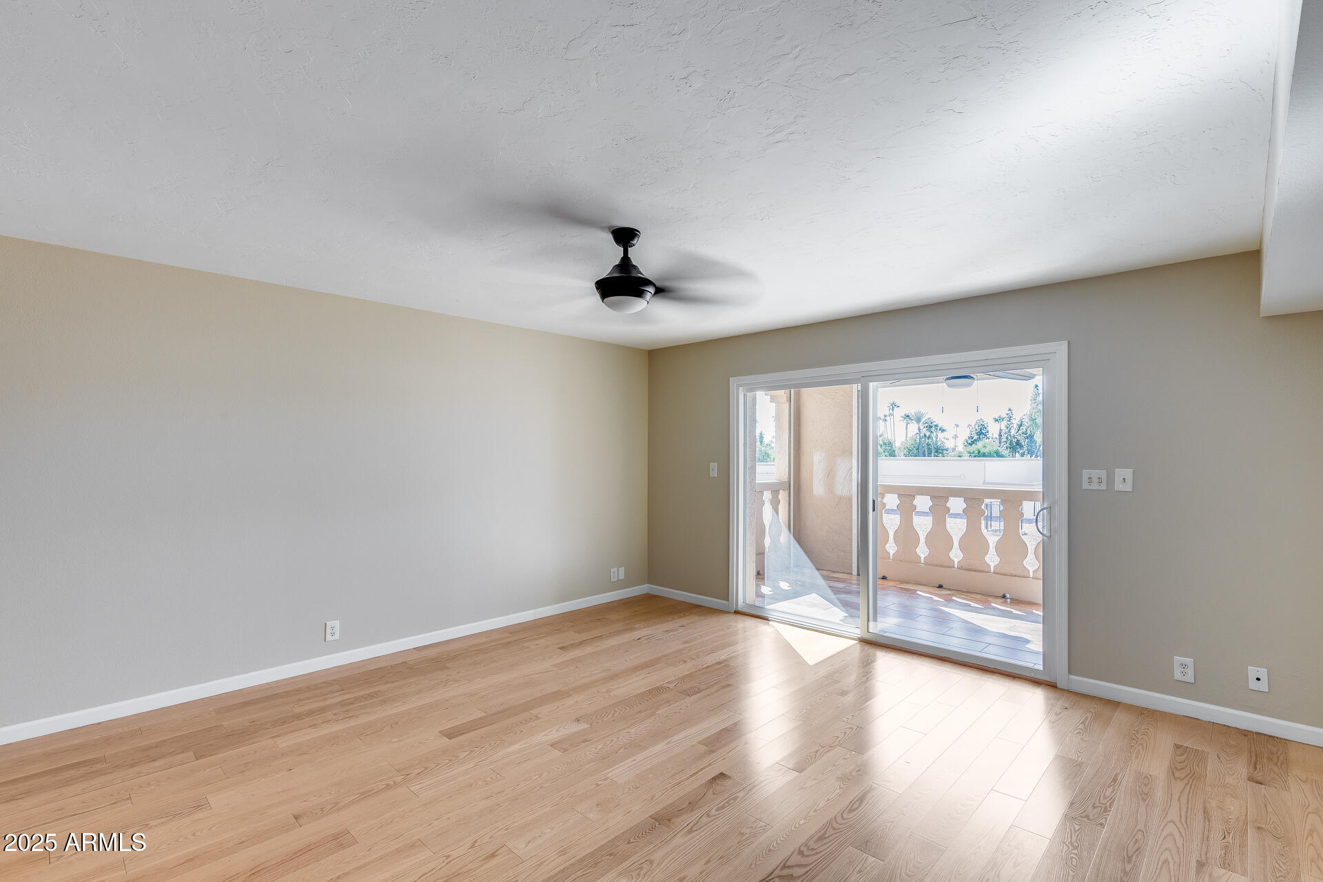 7820 East Camelback Road, Unit 211 Scottsdale, AZ 85251 - Photo 25 of 52 a view of an empty room with wooden floor and a window