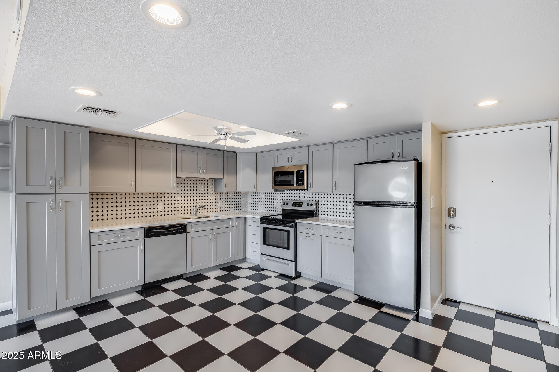 7820 East Camelback Road, Unit 211 Scottsdale, AZ 85251 - Photo 2 of 52 a kitchen with stainless steel appliances granite countertop a refrigerator and a stove top oven