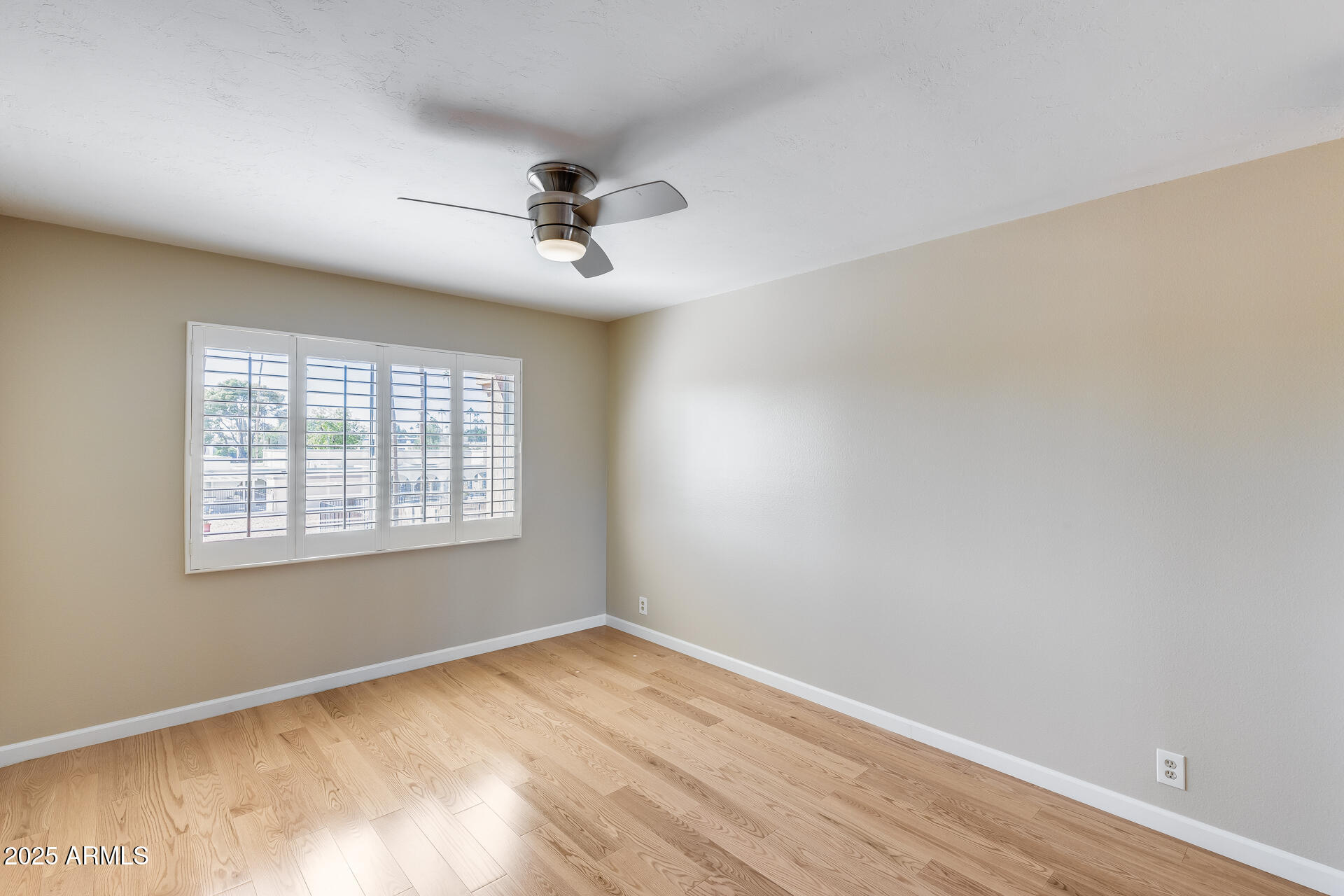 7820 East Camelback Road, Unit 211 Scottsdale, AZ 85251 - Photo 32 of 52 a view of empty room with wooden floor and fan
