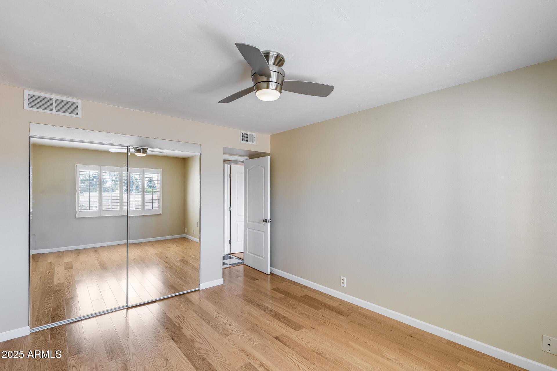 7820 East Camelback Road, Unit 211 Scottsdale, AZ 85251 - Photo 33 of 52 wooden floor in an empty room with a window