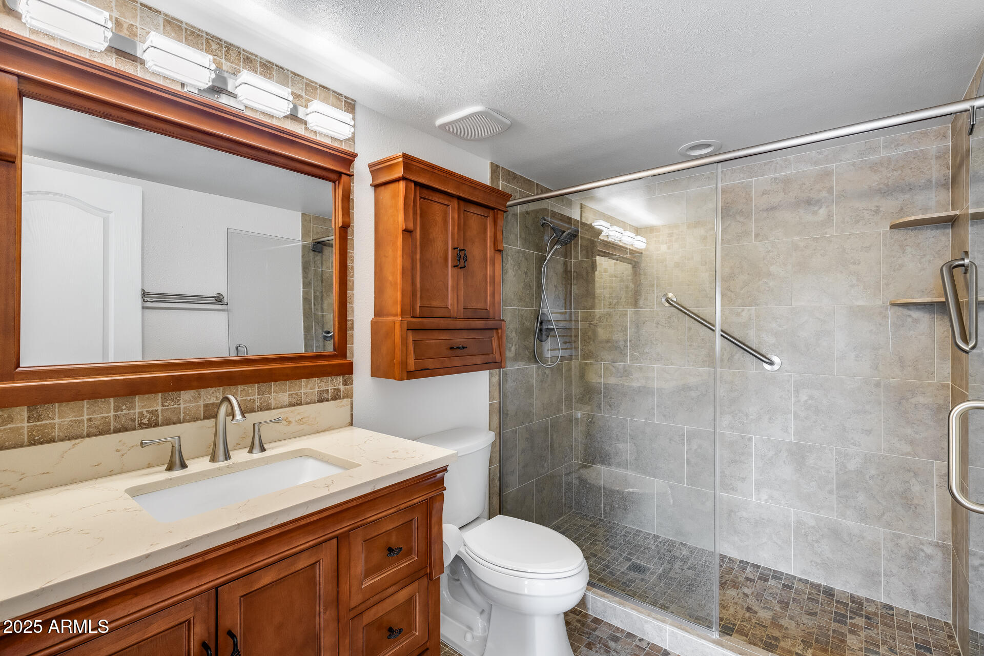 7820 East Camelback Road, Unit 211 Scottsdale, AZ 85251 - Photo 39 of 52 a bathroom with a sink and mirror with toilet