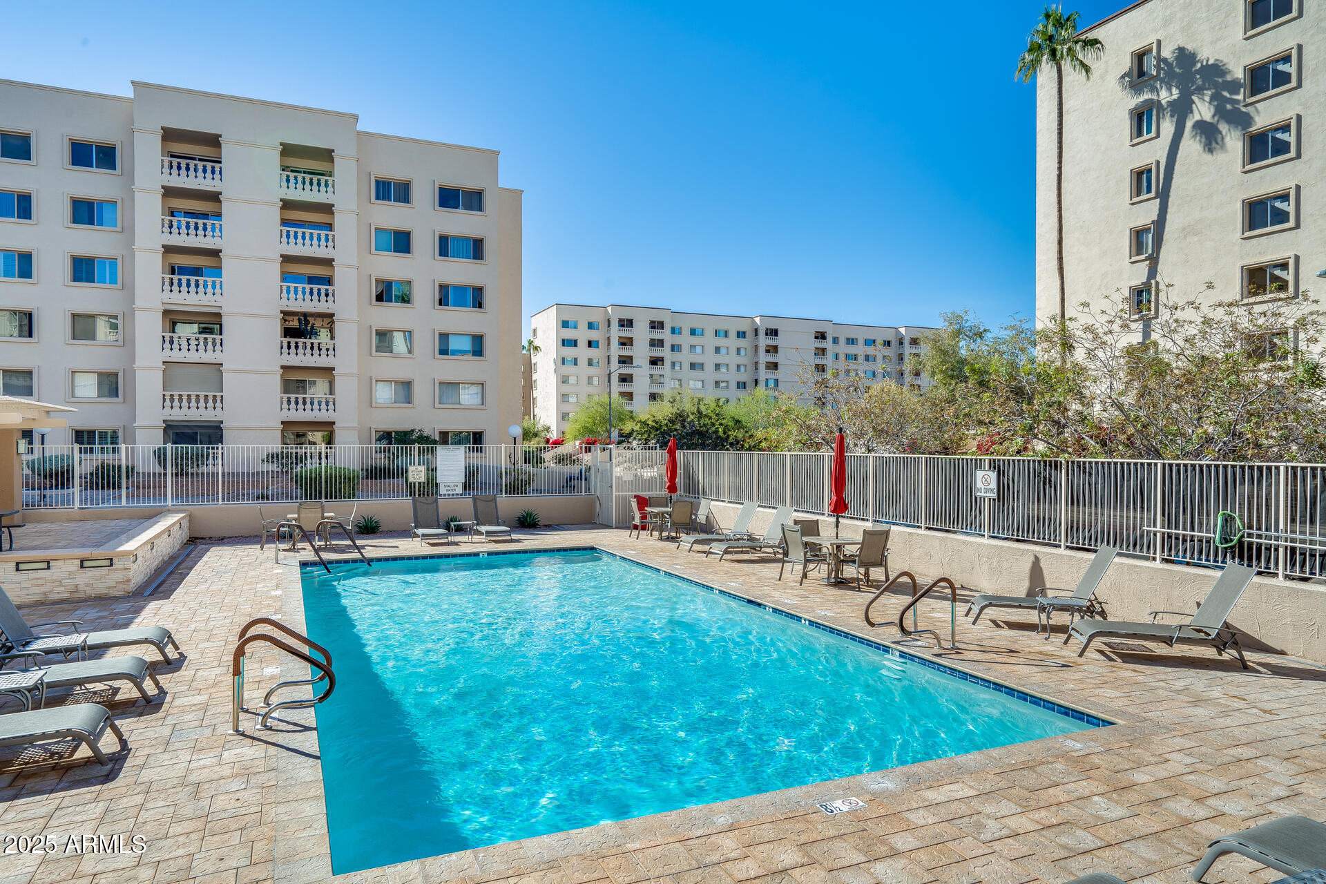 7820 East Camelback Road, Unit 211 Scottsdale, AZ 85251 - Photo 50 of 52 a view of a swimming pool with chairs