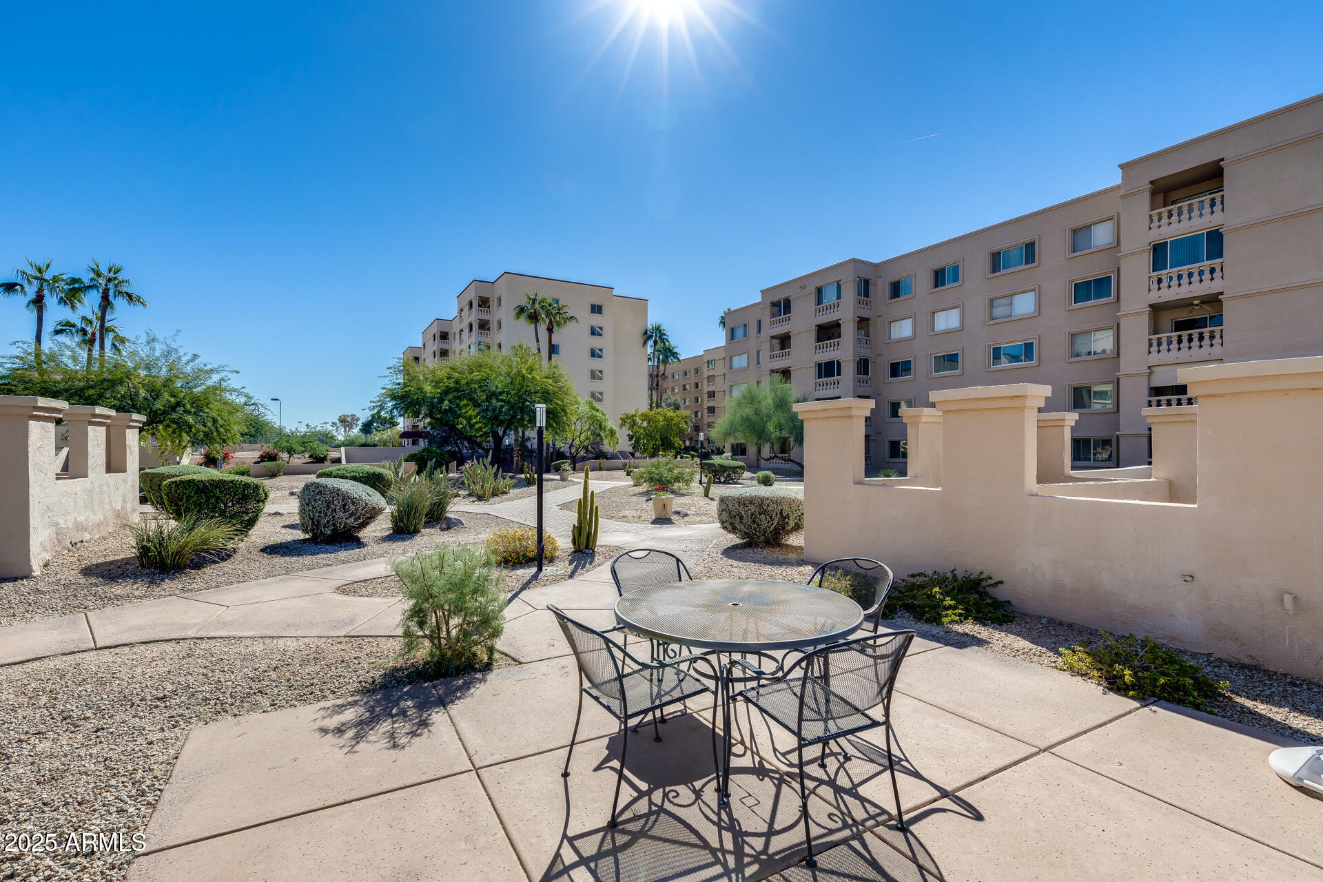 7820 East Camelback Road, Unit 211 Scottsdale, AZ 85251 - Photo 9 of 52 a patio with table and chairs and potted plants