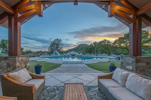 a view of backyard with seating area and green space