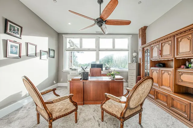 a dining room with furniture a rug and a large window