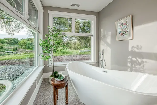 a bath tub sitting in front of a window
