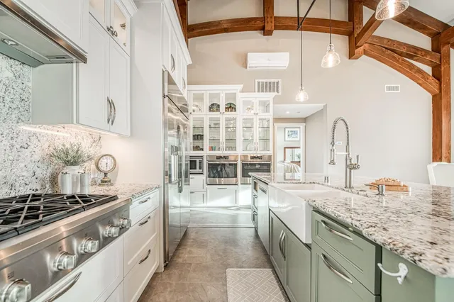 a kitchen with stainless steel appliances granite countertop a stove and a sink