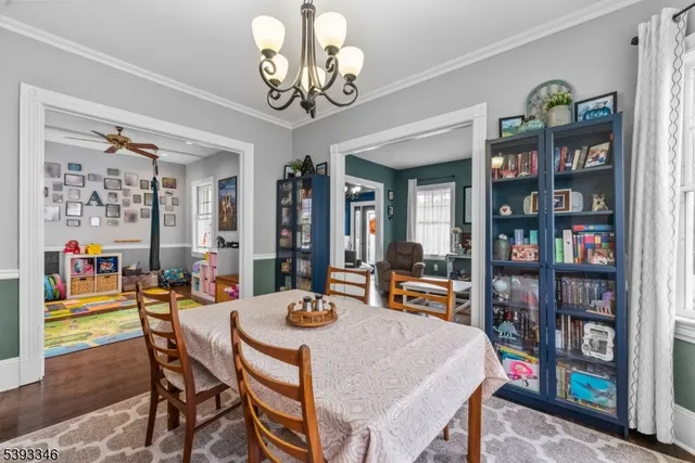 a view of a dining room with furniture and a bookshelf