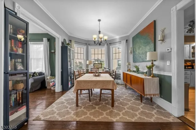 a living room with furniture a chandelier a rug and a chandelier