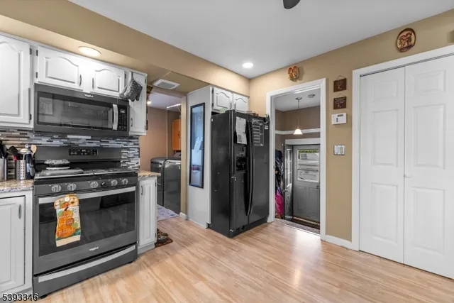 a kitchen with stainless steel appliances granite countertop a refrigerator stove and oven