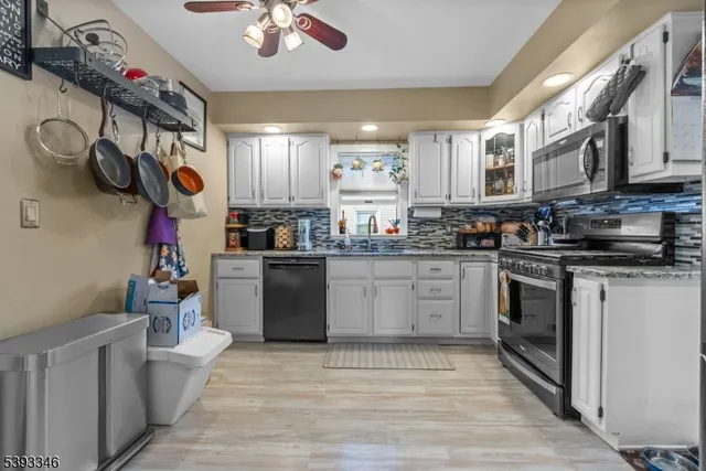 a kitchen with a white cabinets and window