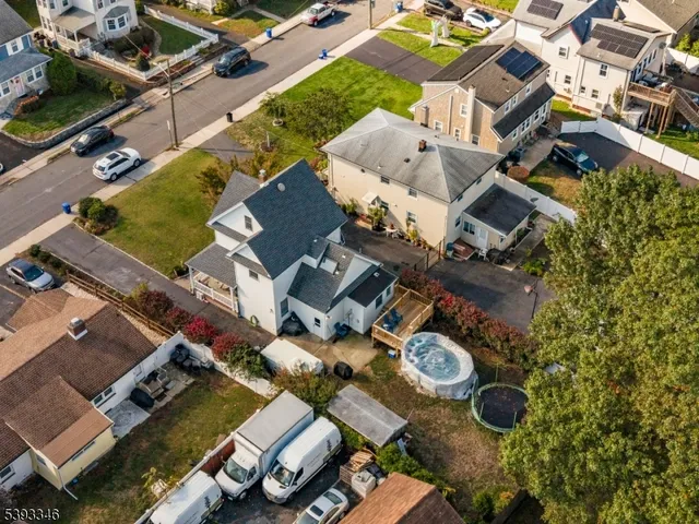 an aerial view of a house with garden space and street view