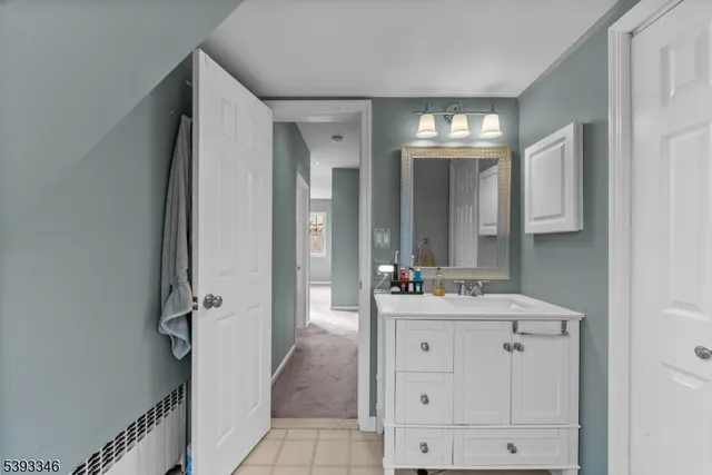 a bathroom with a sink vanity toilet and shower