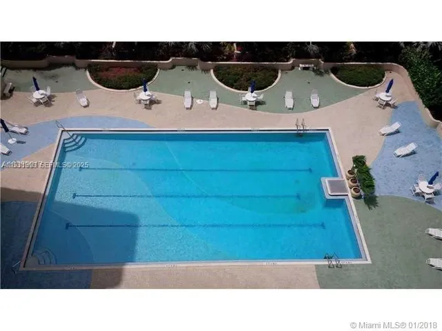a view of a swimming pool and a lawn chairs