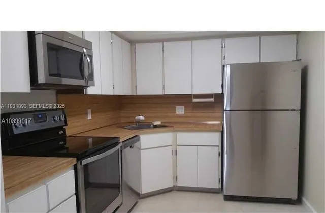 a bathroom with a double vanity sink a large mirror and shower