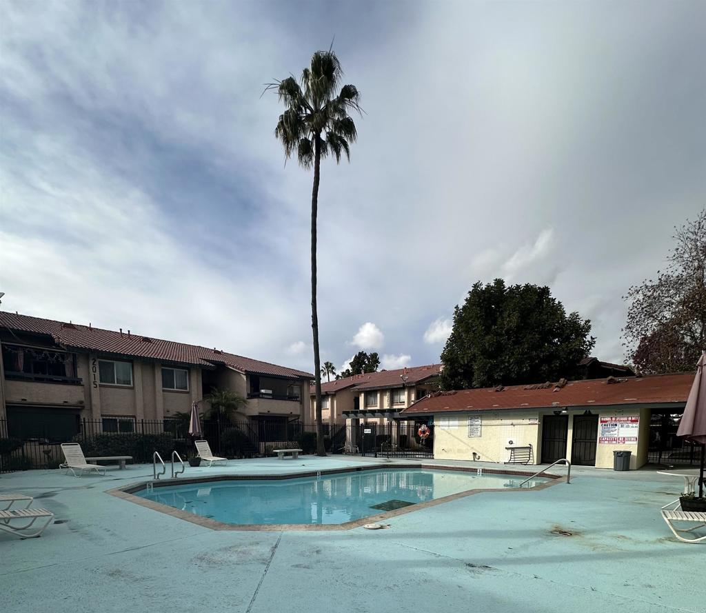 2033 Dairy Mart Road, Unit 13 San Ysidro, CA 92173 - Photo 13 of 14 a front view of a house with a garden and plants