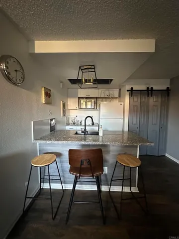 a kitchen with a table chairs and a wooden floor