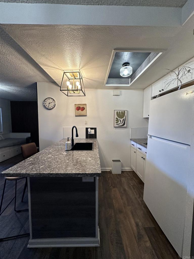 2033 Dairy Mart Road, Unit 13 San Ysidro, CA 92173 - Photo 9 of 14 a utility room with a sink a refrigerator and a stove top oven