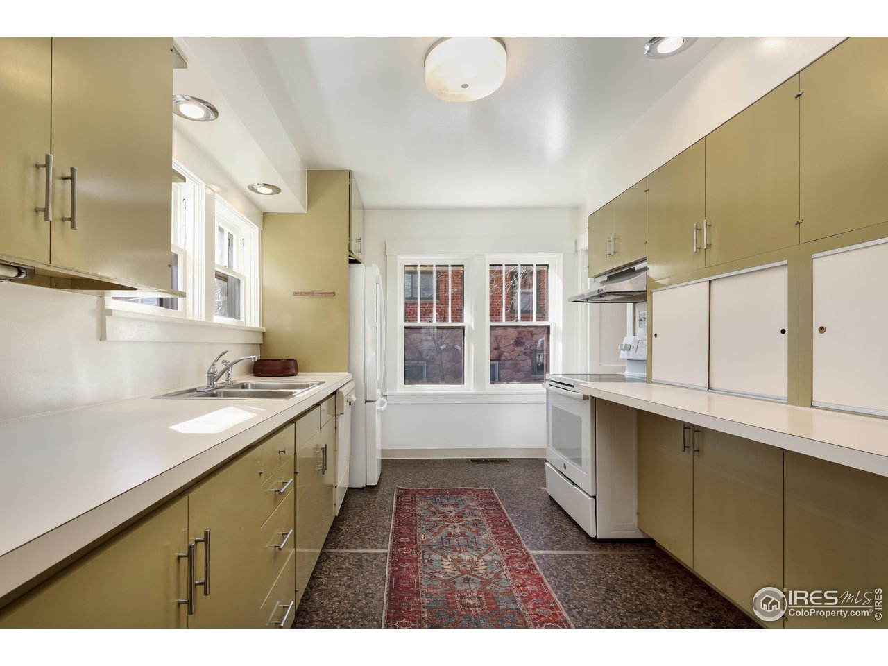 842 Grant Place Boulder, CO 80302 - Photo 16 of 40 a open kitchen with stainless steel appliances granite countertop a sink and cabinets with wooden floor