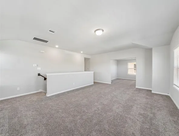 an empty room with a empty space and windows