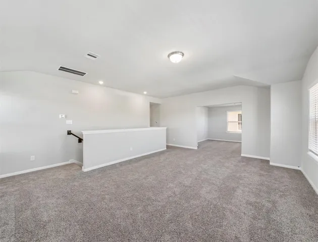 an empty room with a empty space and windows