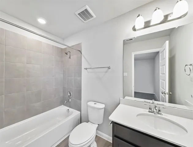 a bathroom with a sink a toilet and bathtub