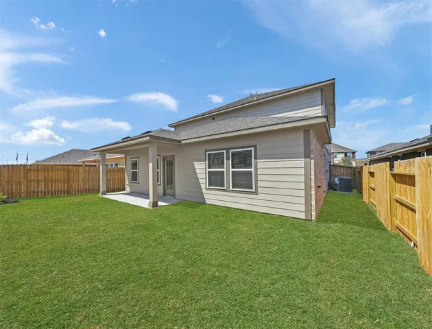 a view of a house with a yard and deck