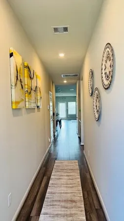 a view of a hallway with paintings on the wall