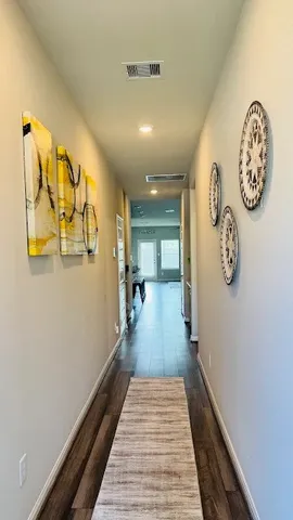 a view of a hallway with paintings on the wall