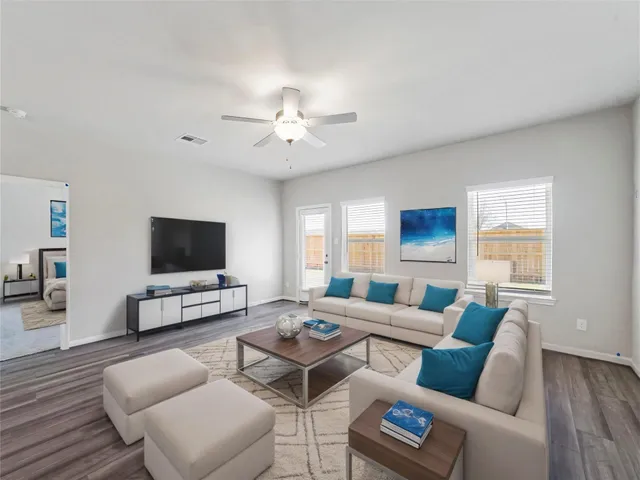 a living room with furniture and a flat screen tv