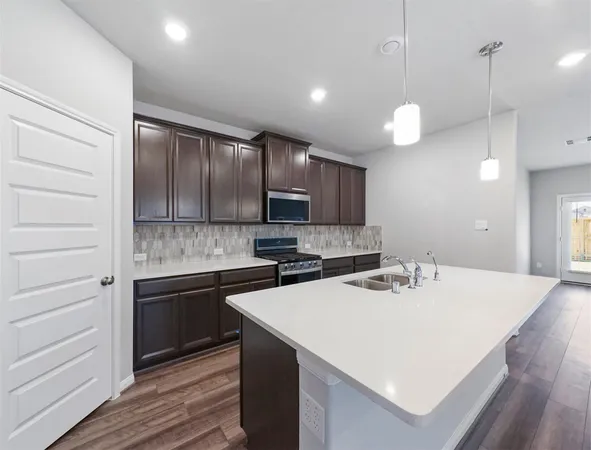 a kitchen with a sink a stove and cabinets