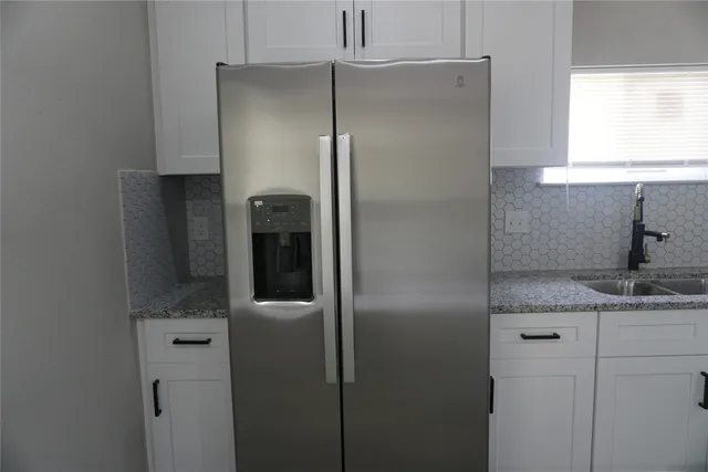 a bathroom with a granite countertop shower a sink and a mirror