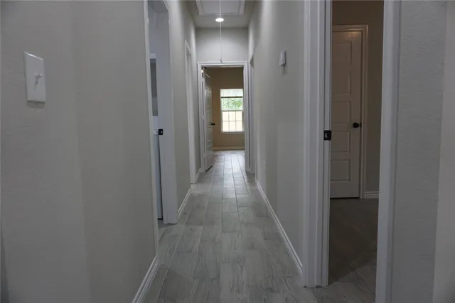 a view of a hallway with wooden floor