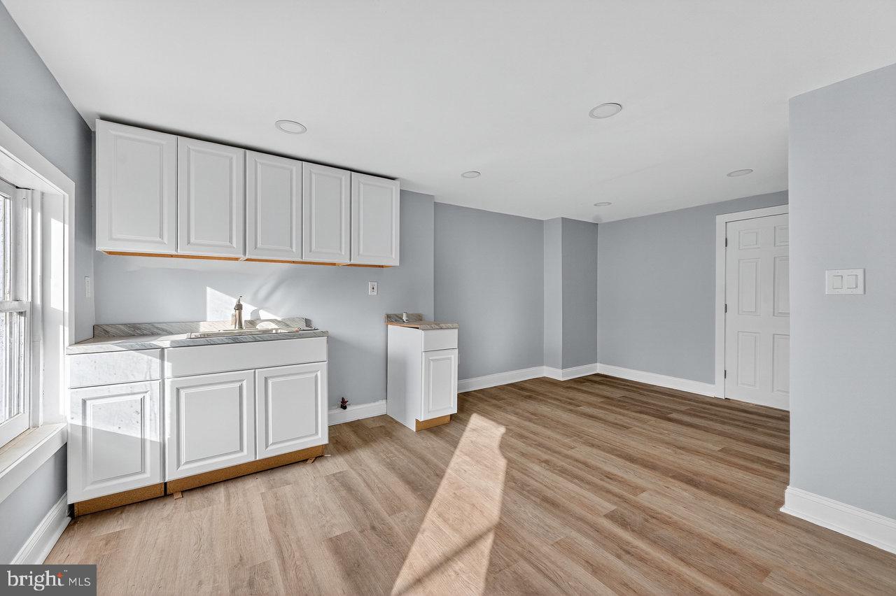 11 North Willow Street, Unit 3 Trenton, NJ 08608 - Photo 3 of 8 a kitchen with granite countertop white cabinets and white appliances