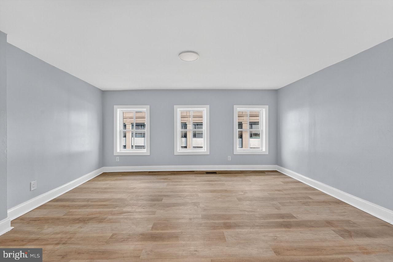 11 North Willow Street, Unit 3 Trenton, NJ 08608 - Photo 6 of 8 a view of an empty room with a window and wooden floor