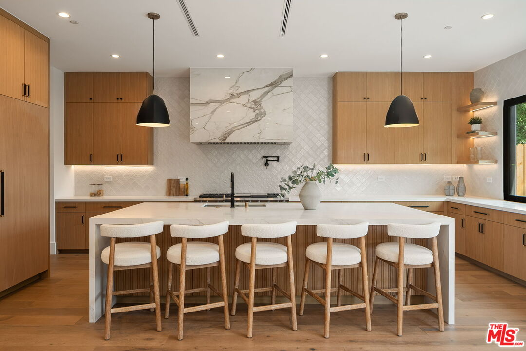 1742 Preuss Road Los Angeles, CA 90035 - Photo 14 of 50 a kitchen with a table chairs sink and microwave