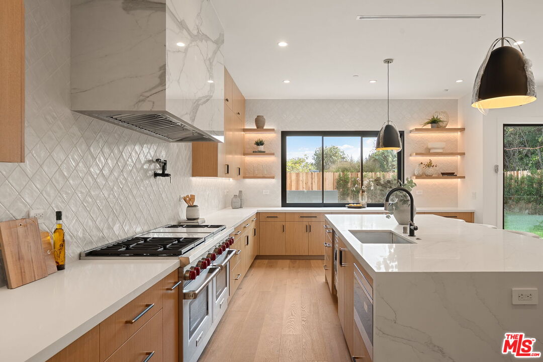 1742 Preuss Road Los Angeles, CA 90035 - Photo 16 of 50 a kitchen that has a sink a stove and a wooden floors