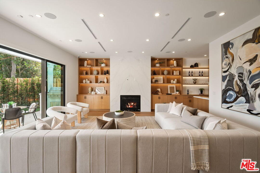 1742 Preuss Road Los Angeles, CA 90035 - Photo 17 of 50 a bedroom with furniture a fireplace and a large window