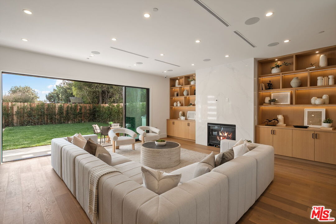 1742 Preuss Road Los Angeles, CA 90035 - Photo 20 of 50 a living room with furniture floor to ceiling window and wooden floor