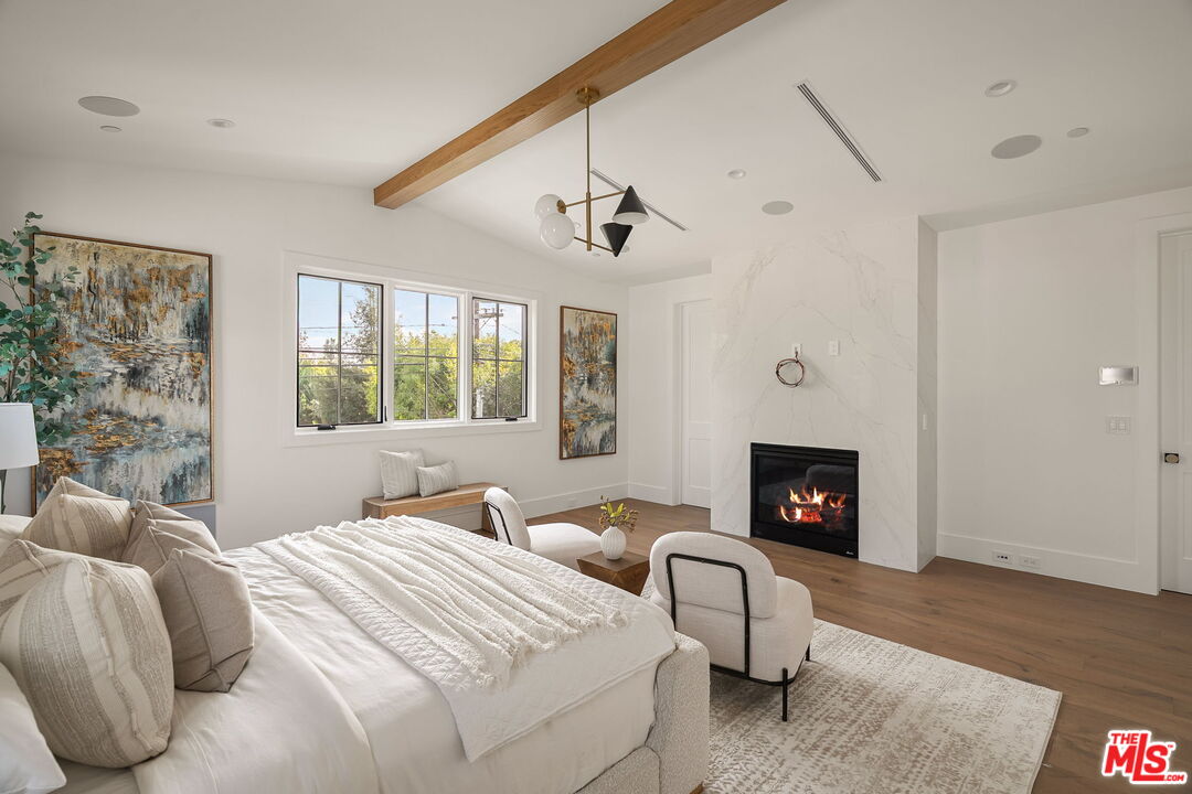 1742 Preuss Road Los Angeles, CA 90035 - Photo 28 of 50 a bedroom with a bed and a fireplace