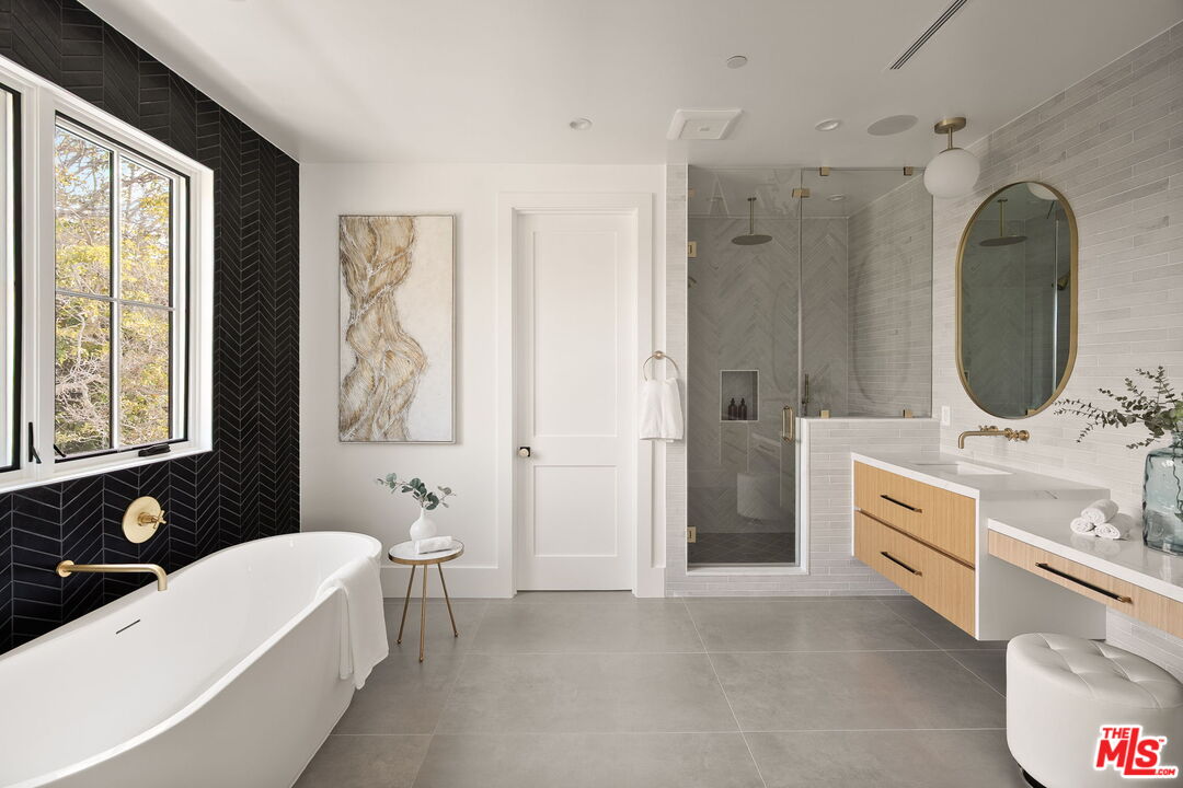 1742 Preuss Road Los Angeles, CA 90035 - Photo 30 of 50 a bathroom with a double vanity sink a mirror a bathtub and shower