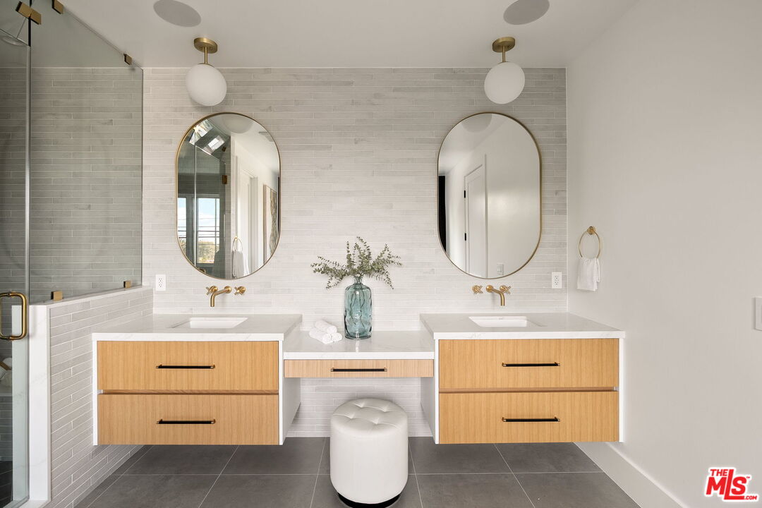 1742 Preuss Road Los Angeles, CA 90035 - Photo 31 of 50 a bathroom with a double vanity sink and a mirror