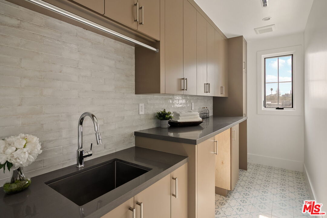 1742 Preuss Road Los Angeles, CA 90035 - Photo 36 of 50 a kitchen with stainless steel appliances granite countertop a sink and cabinets