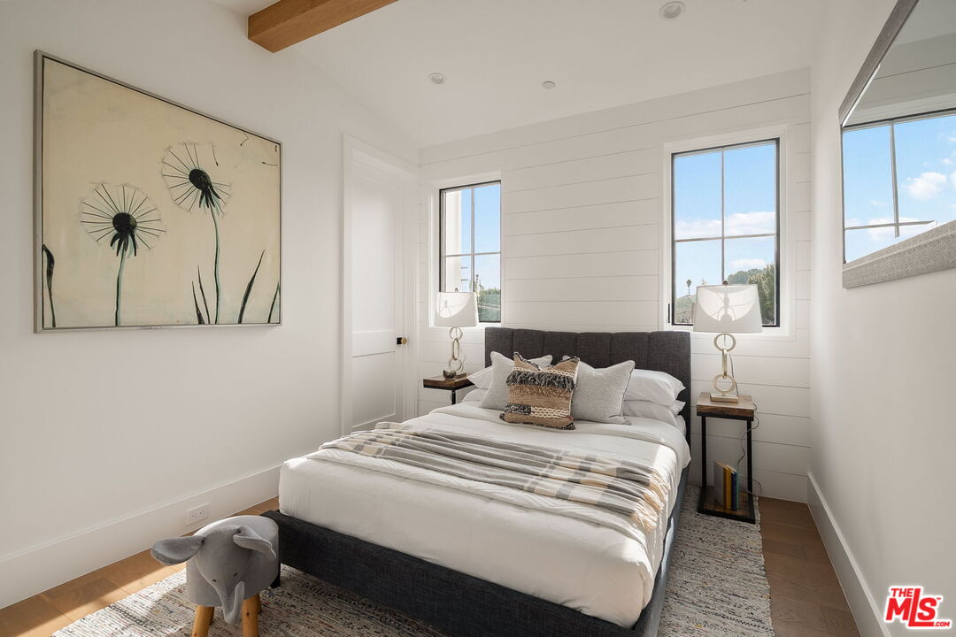 1742 Preuss Road Los Angeles, CA 90035 - Photo 37 of 50 a bedroom with a bed and a painting on the wall