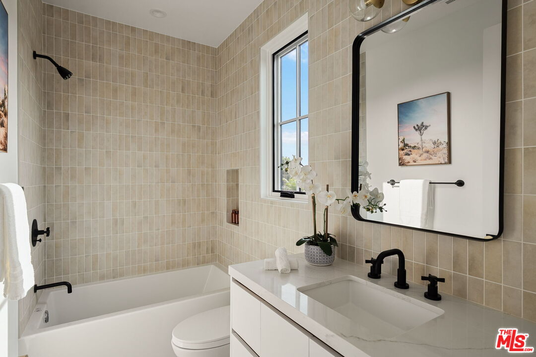 1742 Preuss Road Los Angeles, CA 90035 - Photo 38 of 50 a bathroom with a sink a toilet a mirror and shower