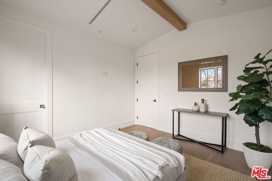 1742 Preuss Road Los Angeles, CA 90035 - Photo 40 of 50 a bedroom with a bed and a potted plant
